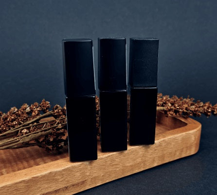 Three bottles of nail tops on top of the wood tray